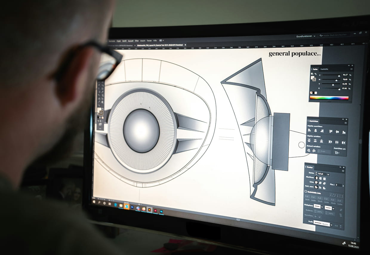 man looking at a computer screen with 3D cad drawings